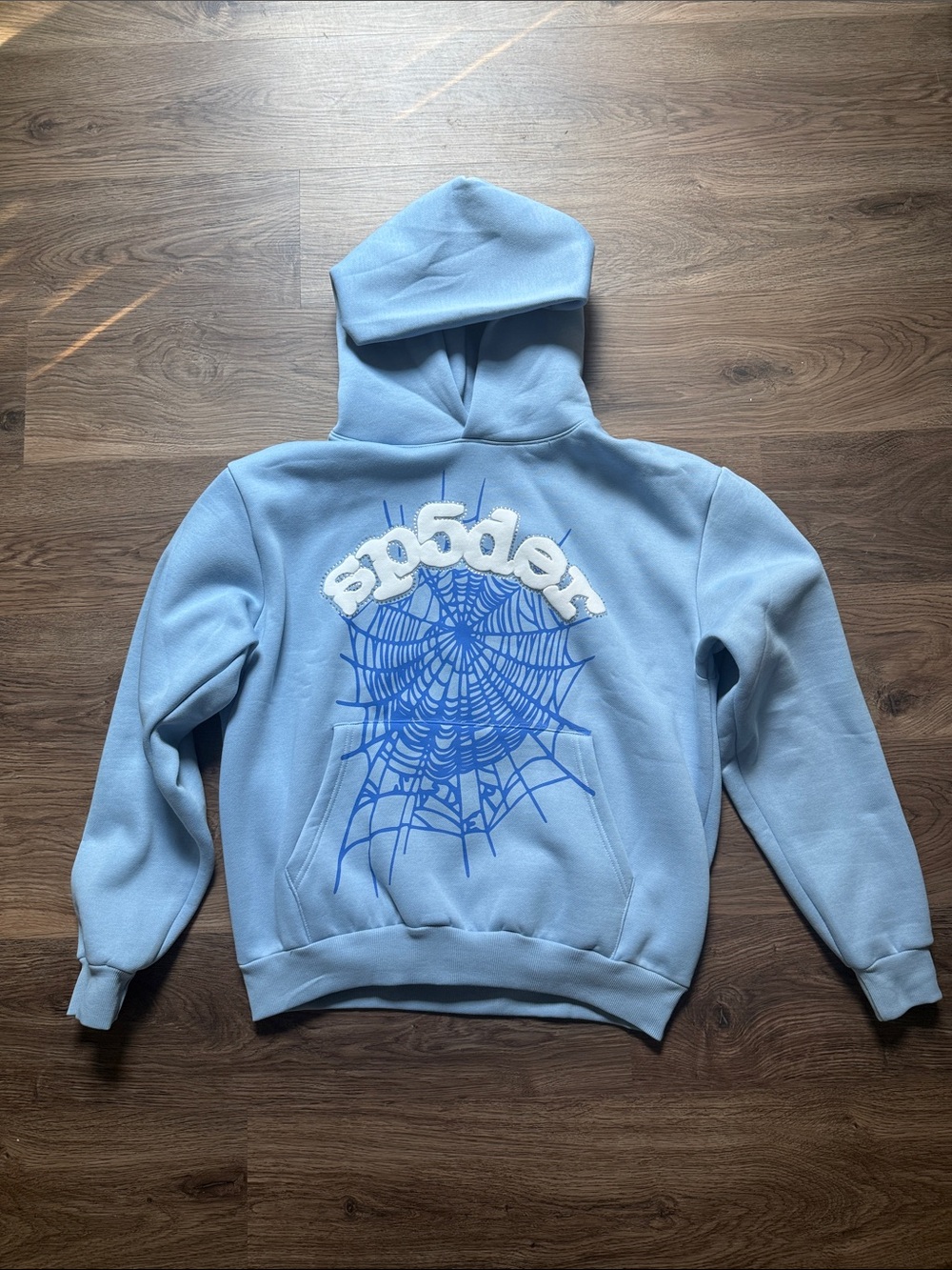 Light Blue Crewneck Hoodie with Blue Spider Web Graphic